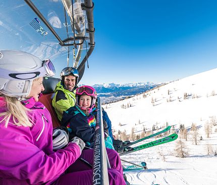 Familie am Sessellift Gerlitzen Alpe Skifahren